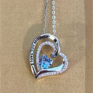 Sterling silver heart pendant necklace with blue topaz heart center